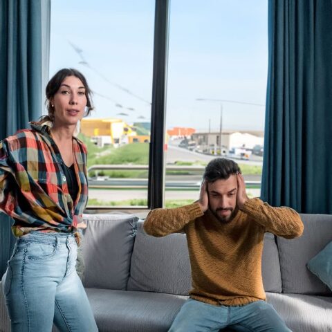 Man covers his ears due to external noise